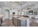 Open concept kitchen with granite countertops, stainless steel appliances, and an island with sink at 204 W Pine Valley Ln, Rotonda West, FL 33947