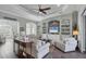 Spacious living room with tray ceilings, built-in shelving, tile floors, and comfortable seating at 204 W Pine Valley Ln, Rotonda West, FL 33947
