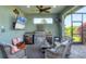 Outdoor kitchen and lounge with a grill, sink, refrigeration, and seating area at 204 W Pine Valley Ln, Rotonda West, FL 33947