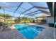 Backyard oasis featuring a sparkling pool, patio, and view of the golf course at 204 W Pine Valley Ln, Rotonda West, FL 33947