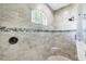 Walk-in shower with a mosaic tile accent stripe, built in bench, and rain shower head at 204 W Pine Valley Ln, Rotonda West, FL 33947