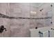 This shower features decorative horizontal tilework, a glass partition, and bronze fixtures at 204 W Pine Valley Ln, Rotonda West, FL 33947
