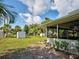 An expansive green backyard featuring a metal shed and a screened-in patio, perfect for outdoor enjoyment at 21519 Fairway Ave, Port Charlotte, FL 33952