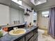 Bathroom featuring a functional vanity, updated fixtures, and shower-tub combo, creating a relaxing oasis at 21519 Fairway Ave, Port Charlotte, FL 33952