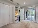 Inviting bedroom with neutral carpet, built-in shelving, and sliding doors that lead to the outdoors at 21519 Fairway Ave, Port Charlotte, FL 33952