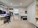 Spacious carpeted bedroom features organized storage shelves and natural light, creating a versatile space at 21519 Fairway Ave, Port Charlotte, FL 33952