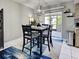 Casual dining area with outdoor access to the porch, featuring a modern light fixture at 21519 Fairway Ave, Port Charlotte, FL 33952