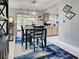 Dining area with a modern table set, stylish lighting, and a view into the updated kitchen at 21519 Fairway Ave, Port Charlotte, FL 33952