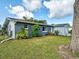 Charming single-story home with a blue brick facade and well-maintained front lawn at 21519 Fairway Ave, Port Charlotte, FL 33952