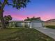 Charming single story home boasts brick accents, a manicured lawn, and an attached two car garage at 21519 Fairway Ave, Port Charlotte, FL 33952