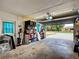 A spacious garage with an open door, offering ample storage space and parking; shelves add extra organization at 21519 Fairway Ave, Port Charlotte, FL 33952