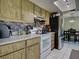 A kitchen with stainless steel refrigerator and view into dining area at 21519 Fairway Ave, Port Charlotte, FL 33952