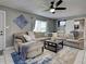 Open living room boasts tile floors, modern furniture, and abundant natural light from the window at 21519 Fairway Ave, Port Charlotte, FL 33952
