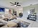 Bright living area with comfortable seating, a ceiling fan, and seamless flow to the dining space at 21519 Fairway Ave, Port Charlotte, FL 33952