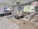 Well lit living space showcases stylish décor, tile floors, and a large sectional sofa for relaxation at 21519 Fairway Ave, Port Charlotte, FL 33952
