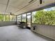 Enclosed sunroom featuring a grill and views of the outdoor greenery through large windows at 21519 Fairway Ave, Port Charlotte, FL 33952