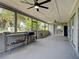 Spacious sunroom with ceiling fans, surrounded by screens to enjoy the outdoors in comfort at 21519 Fairway Ave, Port Charlotte, FL 33952