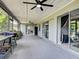 Large screened-in patio with multiple access points and ceiling fans, great for outdoor living at 21519 Fairway Ave, Port Charlotte, FL 33952