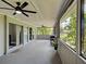 Relaxing sunroom with ceiling fans, sliding glass doors and views of the backyard at 21519 Fairway Ave, Port Charlotte, FL 33952