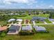A tranquil aerial view showcases this idyllic neighborhood near a golf course and a shimmering lake at 22 Par View Rd, Rotonda West, FL 33947