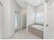 Serene bathroom featuring a soaking tub, separate shower, and white-painted cabinetry at 22 Par View Rd, Rotonda West, FL 33947