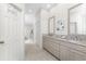 Neutral bathroom with granite counters, double vanity, and tiled floors at 22 Par View Rd, Rotonda West, FL 33947