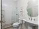Modern bathroom with large glass shower, pedestal sink, and decorative mirror at 22 Par View Rd, Rotonda West, FL 33947