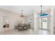 Elegant dining room featuring a stylish chandelier, a large table, and bright natural light at 22 Par View Rd, Rotonda West, FL 33947
