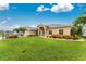 Landscaped front yard with a large, well-maintained lawn and a charming home at 22 Par View Rd, Rotonda West, FL 33947