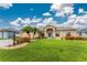 Well-manicured front yard featuring lush green lawn and tropical landscaping at 22 Par View Rd, Rotonda West, FL 33947