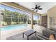 Relaxing covered lanai with seating area overlooking the screened-in pool at 22 Par View Rd, Rotonda West, FL 33947