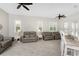 Bright living room features tile flooring, neutral paint, plantation shutters, and comfortable seating at 22 Par View Rd, Rotonda West, FL 33947