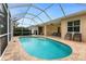 Serene pool area with fountain, covered patio, seating, and a screened enclosure at 22 Par View Rd, Rotonda West, FL 33947