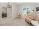Cozy sitting area showcasing a comfortable armchair, a vintage table lamp, and a bright window at 22 Par View Rd, Rotonda West, FL 33947