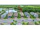 A neighborhood with well-kept homes, a tranquil pond, and lush greenery in a serene setting at 2592 Brassica Dr, North Port, FL 34289