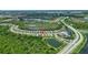 An aerial view of a community with lakes, lush greenery, and a well-designed road network at 2592 Brassica Dr, North Port, FL 34289