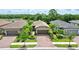 Well-maintained homes showcase brick driveways, lush landscaping, and a serene neighborhood setting at 2592 Brassica Dr, North Port, FL 34289