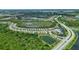 An aerial view of a community with lakes, lush greenery, and a well-designed road network at 2592 Brassica Dr, North Port, FL 34289