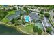 A community clubhouse features a pool, tennis courts, playground, and landscaped grounds by a pond at 2592 Brassica Dr, North Port, FL 34289