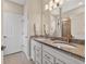 Bathroom with dual sinks, granite countertop and tiled shower at 2592 Brassica Dr, North Port, FL 34289