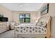 Comfortable bedroom featuring coastal decor, a cozy chair, and a dresser with a TV at 2592 Brassica Dr, North Port, FL 34289