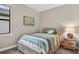 Cozy bedroom featuring a comfortable bed, nightstand, and window offering natural light at 2592 Brassica Dr, North Port, FL 34289