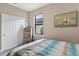 Well-lit bedroom with closet, complemented by nautical decor and natural light from a window at 2592 Brassica Dr, North Port, FL 34289