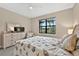 Cozy bedroom with a queen bed, dresser, and large window for natural light at 2592 Brassica Dr, North Port, FL 34289