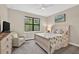 Relaxing bedroom featuring neutral tones, coastal accents, and a sunlit window at 2592 Brassica Dr, North Port, FL 34289
