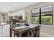 Dining area with seating for four and views of kitchen at 2592 Brassica Dr, North Port, FL 34289