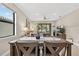 Dining area with seating for four and view of living room and outdoor patio at 2592 Brassica Dr, North Port, FL 34289