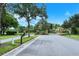 Community entrance featuring iron gates, brick pillars, and lush landscaping providing security and curb appeal at 2592 Brassica Dr, North Port, FL 34289