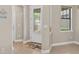 Bright foyer with a decorative glass front door, tile floors, and a view into other rooms at 2592 Brassica Dr, North Port, FL 34289