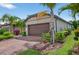 Charming single-story home with a brick driveway, mature landscaping and a two-car garage at 2592 Brassica Dr, North Port, FL 34289
